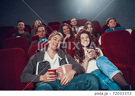 A young couple came to the cinema for a comedy.  72033353