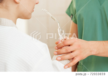 Woman receives nasal inhalation. Woman receives nasal inhalation. 72033659