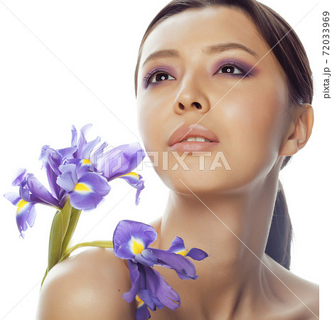 young pretty real asian woman with flower purple orchid isolated on white background spa, healthcare concept 72033969