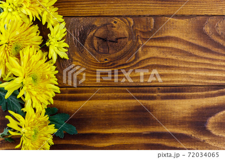 Yellow chrysanthemums on wooden background. Top view, copy space Yellow chrysanthemums on wooden background. Top view, copy space 72034065