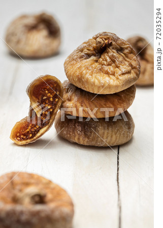 Dried figs on a white wooden background Dried figs on a white wooden background 72035294