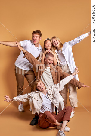 cheerful young people spread arms, ready to fly 72036026