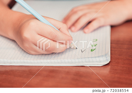 Close up of child writing letters in notebook 72038554