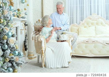 Happy senior couple preparing for Christmas at home Happy senior couple preparing for Christmas at home 72040416