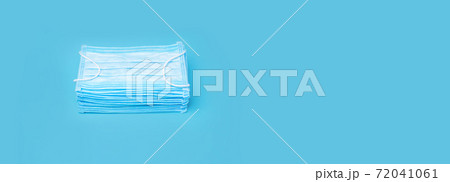 Masks on Blue Background with Copy Space. Stacked Medical Mask. Prevention Concept. Pile Mask. Set Disposable Mask. Many Blue 3-ply Surgical Mask. Prevention Concept. Protection against Coronavirus 72041061