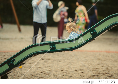 blonde haired girl on the slide 72041123