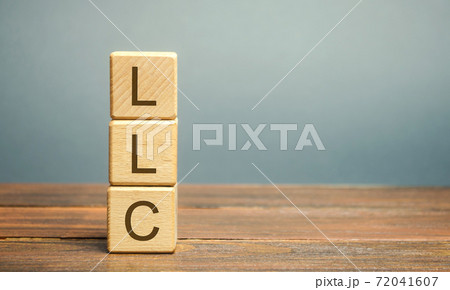 Wooden blocks with LLC - Limited Liability Company. Business concept. Hybrid companies that combine the characteristics of a corporation and a partnership. Business form permitted by state regulations Wooden blocks with LLC - Limited Liability Company. Business concept. Hybrid companies that combine the characteristics of a corporation and a partnership. Business form permitted by state regulations 72041607