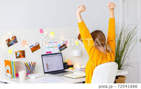 Cheerful woman celebrating project accomplishment at home. 72041886