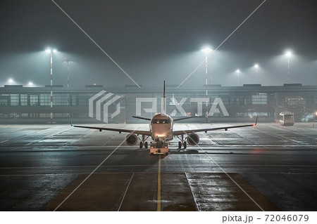 Airliner at an airport at night Airliner at an airport at night 72046079