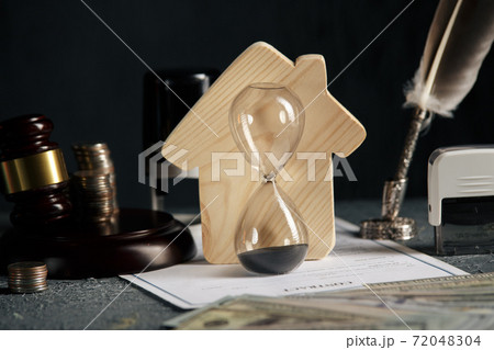 Model of house, stamp, gavel and hourglass on desk. Home real estate and auction concept Model of house, stamp, gavel and hourglass on desk. Home real estate and auction concept 72048304
