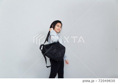 Asian little girl with backpack on grey background 72049630