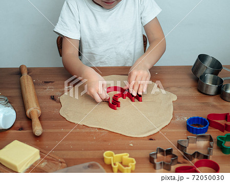 Son in kitchen making cookies 72050030