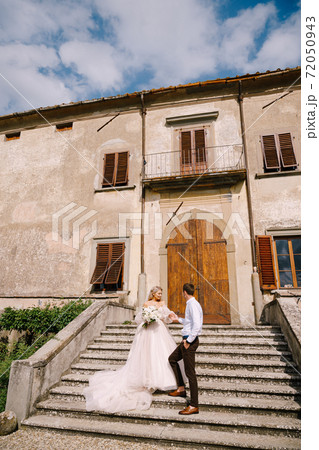 Wedding in Florence, Italy, in an old villa-winery. Wedding couple walks in the garden. Loving bride and groom. Wedding in Florence, Italy, in an old villa-winery. Wedding couple walks in the garden. Loving bride and groom. 72050943
