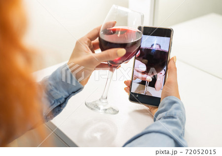 The women talk over video communication on the phone and drink red wine. The quarantined girl is not making a video call The women talk over video communication on the phone and drink red wine. The quarantined girl is not making a video call 72052015