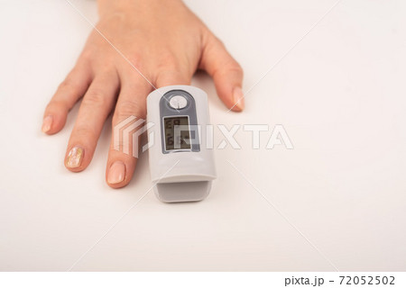 Female hand with a measuring device saturation. Blood oxygen level in coronavirus Female hand with a measuring device saturation. Blood oxygen level in coronavirus 72052502