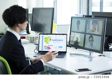 在宅スタッフとオンライン会議するオフィスの男性 72053408