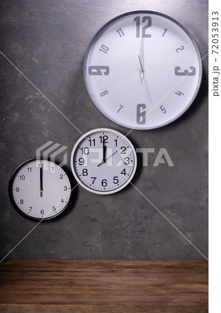 twelve o'clock at wall clock with concrete background 72053913