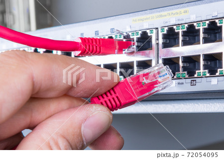 hand with red ethernet cable hand with red ethernet cable 72054095
