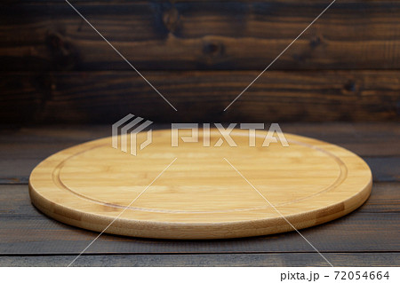 pizza cutting board at rustic wooden table Stock Photo by seregam