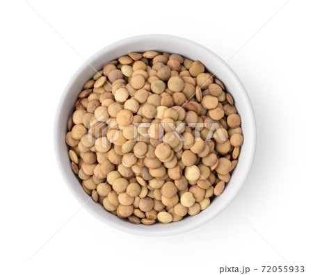 Uncooked lentils in white bowl isolated on white background 72055933