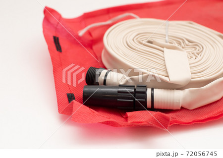 Rolled up firefighter hose reel on red bag 72056745