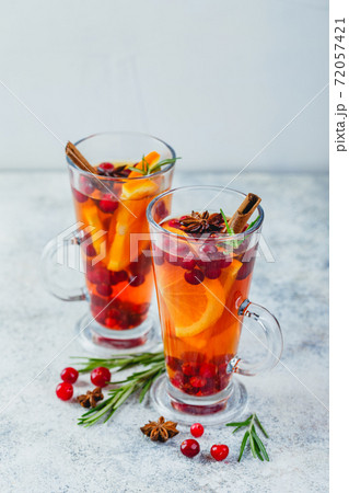 Orange and cranberry drinks with orange slices and spices. Hot drinks for winter and Christmas 72057421