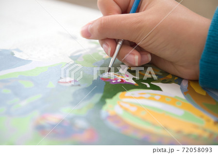 1 - Close up of young female hand painting by numbers. Horizontal 72058093