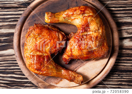 Chicken leg quarters on a wooden background Chicken leg quarters on a wooden background 72058390
