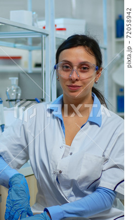 Tired laboratory doctor looking at camera smiling 72058942