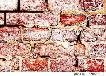 Texture of a brick wall with cracks and scratches which can be used as a background Texture of a brick wall with cracks and scratches which can be used as a background 72061590