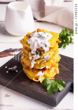 Fried cakes of grated potatoes on the plate with sauce. Traditional pancakes boxty raggmunk. Fried cakes of grated potatoes on the plate with sauce. Traditional pancakes boxty raggmunk. 72062234