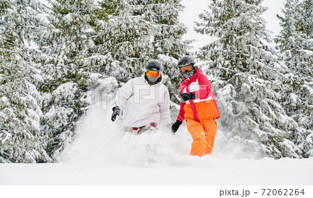 Skiers having fun in winter mountain forest. Skiers having fun in winter mountain forest. 72062264
