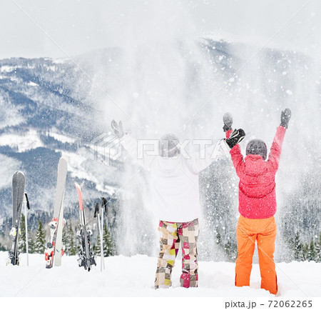Friends skiers having fun at ski resort in the mountains in winter, skiing and snowboarding 72062265