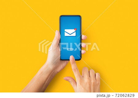 Online correspondence. Top view of young lady pressing READ button on cellphone with incoming email, orange background 72062829