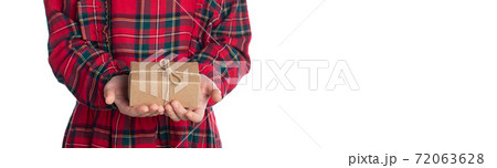 Little girl's hands holding present in brown craft paper box 72063628