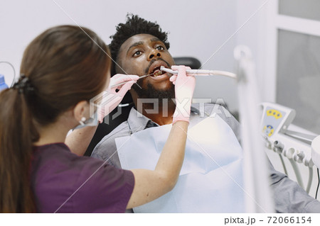 African patient in dentistry sitting in dental chair 72066154