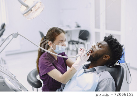African patient in dentistry sitting in dental chair 72066155