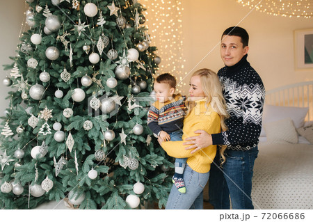 Young family spend time at home in Christmas time. Happy Mom, dad and son enjoyng love hugs, holidays people. Togetherness concept 72066686