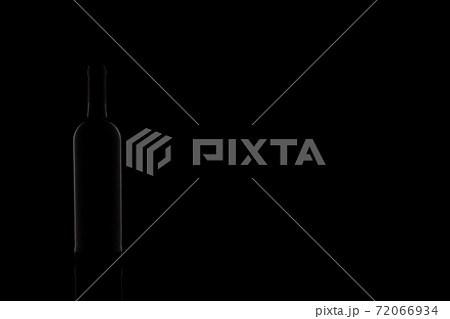 Wine bottle silhouette isolated on dark background. Studio photography. 72066934