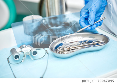 Close-up of dentist's hands and dental equipment 72067095