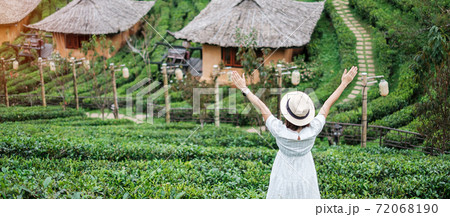 Happy tourist woman in white dress enjoy beautiful Tea garden.Traveler visiting in Ban Rak Thai village, Mae Hong Son, Thailand. travel, vacation and holiday concept Happy tourist woman in white dress enjoy beautiful Tea garden.Traveler visiting in Ban Rak Thai village, Mae Hong Son, Thailand. travel, vacation and holiday concept 72068190