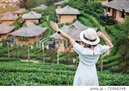 Happy tourist woman in white dress enjoy beautiful Tea garden.Traveler visiting in Ban Rak Thai village, Mae Hong Son, Thailand. travel, vacation and holiday concept Happy tourist woman in white dress enjoy beautiful Tea garden.Traveler visiting in Ban Rak Thai village, Mae Hong Son, Thailand. travel, vacation and holiday concept 72068246