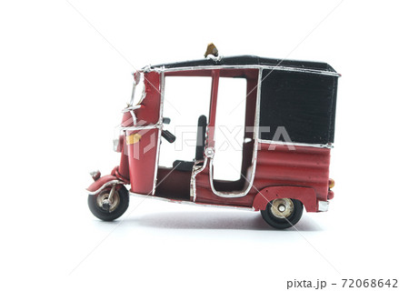 Closeup of miniature retro tuc tuc on white background Closeup of miniature retro tuc tuc on white background 72068642