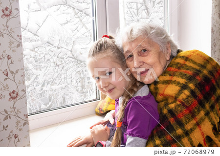 Happy beautiful great grandmother and her adorable granddaughter 72068979