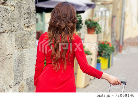 Woman walks with suitcase. Woman walks with suitcase. 72069146