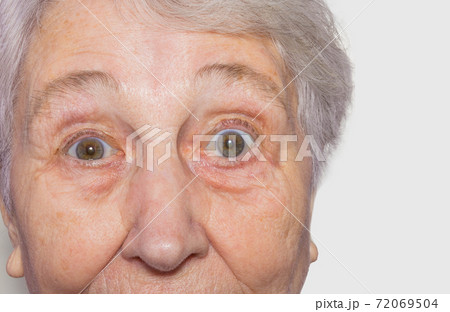 Close up view of senior woman's face on white background 72069504