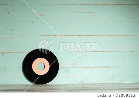 Vinyl record on vintage wooden background 72069552