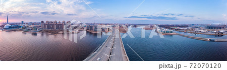 Aerial Panoramic view to evening St. Petersburg and Cable-stayed bridge across Petrovsky fairway. Western high-speed diameter WHSD at sunset. Modern highway along Neva river in a summer day. Russia. 72070120