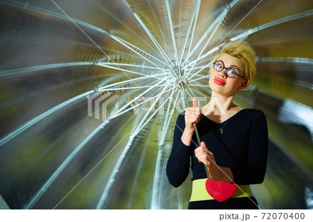 The clown with an umbrella. Health and fun concept. The clown with an umbrella. Health and fun concept. 72070400