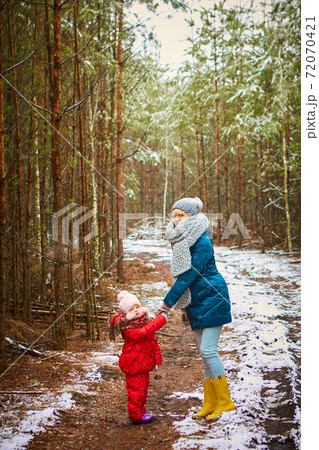 Young mother plays with her baby on a winter day Young mother plays with her baby on a winter day 72070421